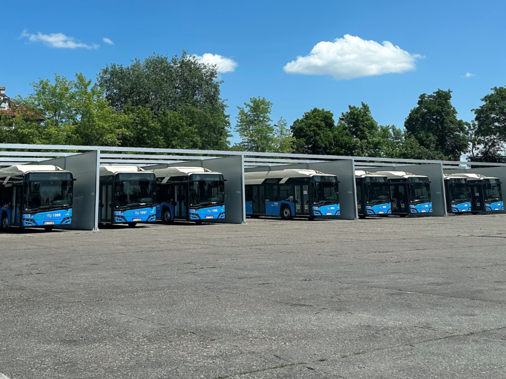 Dozens of blue Solaris electric buses in a coach station