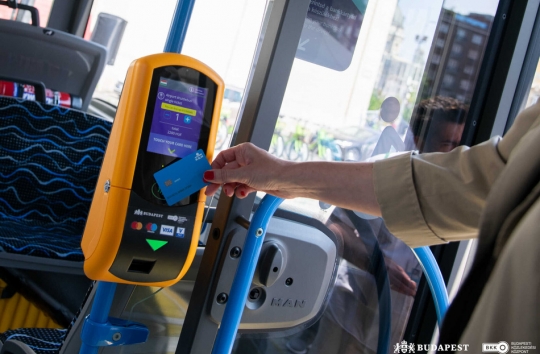 An image of somebody tapping onto a bus using their credit card using wireless fare technology