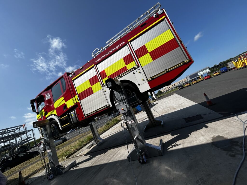 A fire engine in an outdoor wash bay
