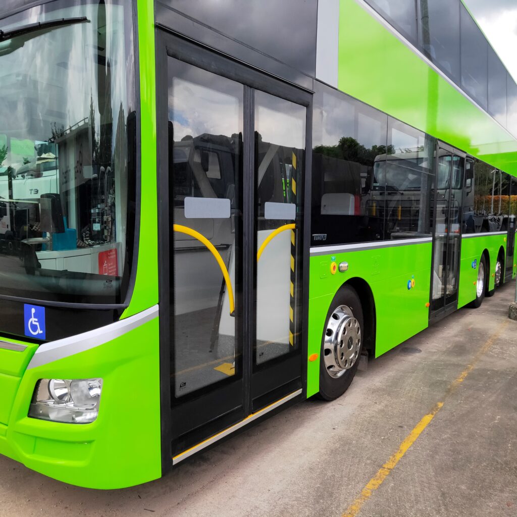 An image of a green bus from the front
