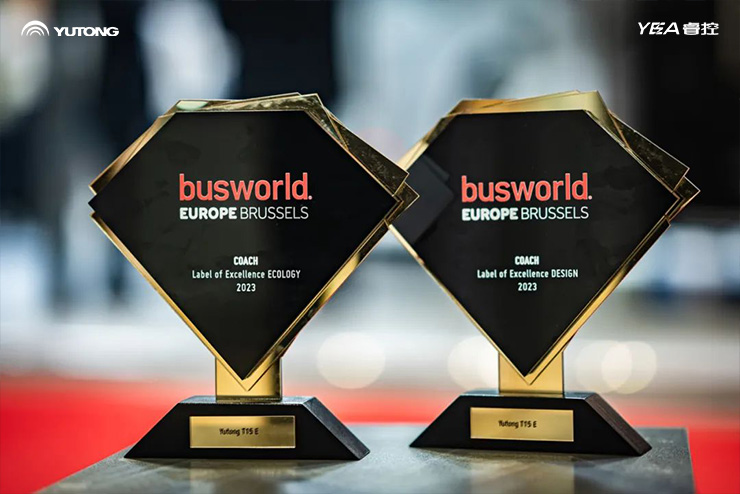 Two black diamond shaped awards with the busworld logo on them
