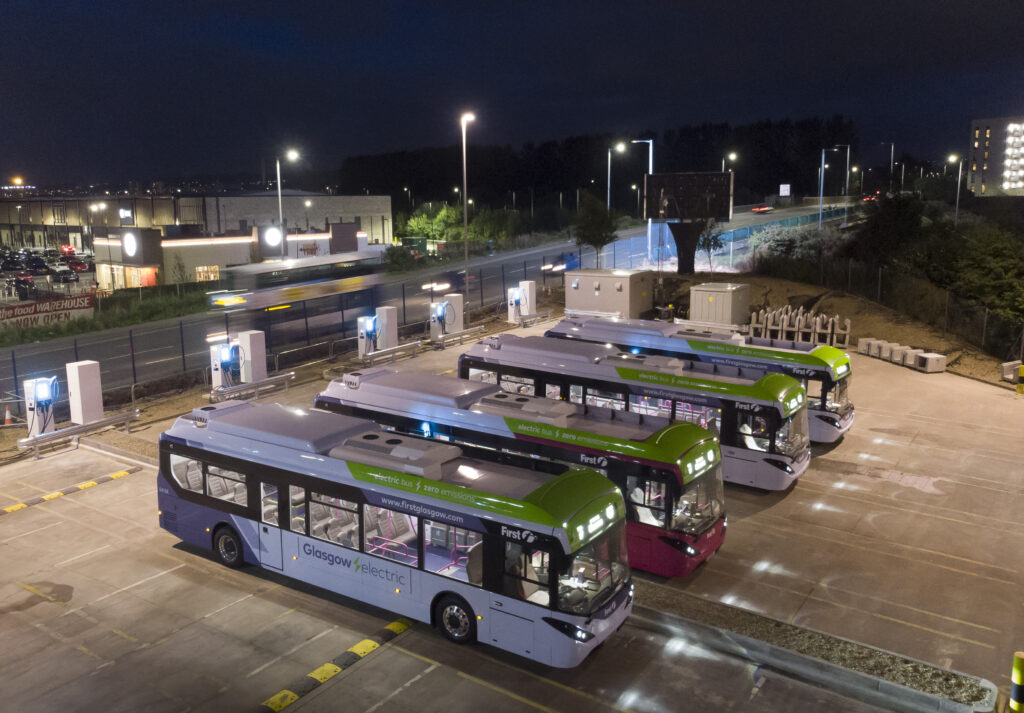 First Buses parked at a depot at night