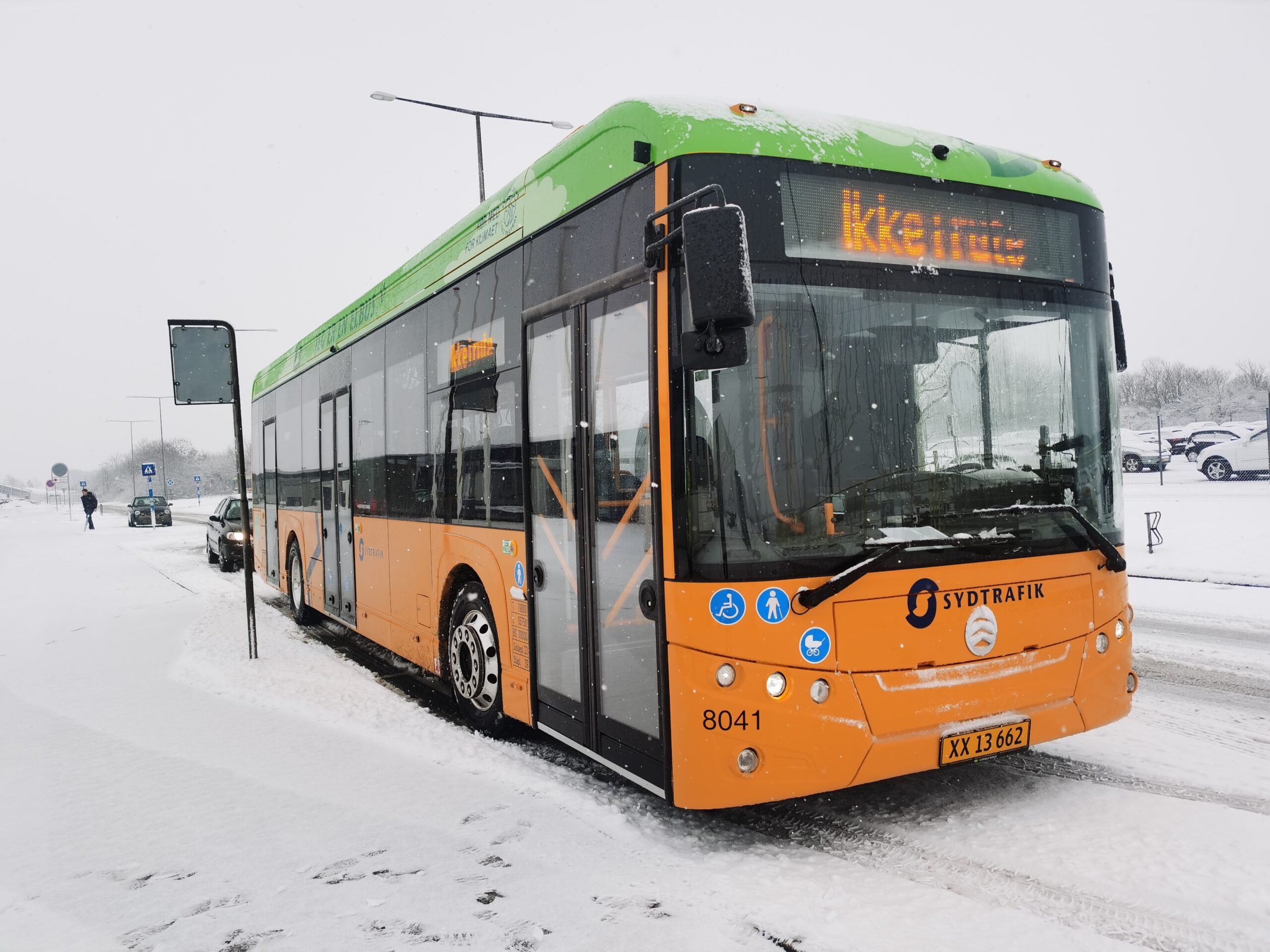 An orange bus in the snow