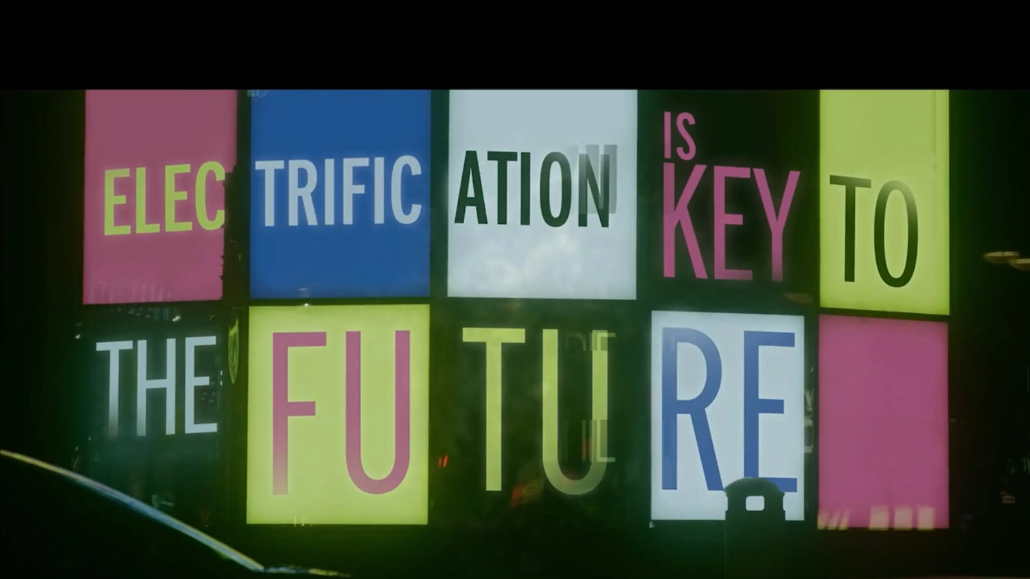 Graphic with multicoloured squares spelling out "Electrification is Key to the Future"