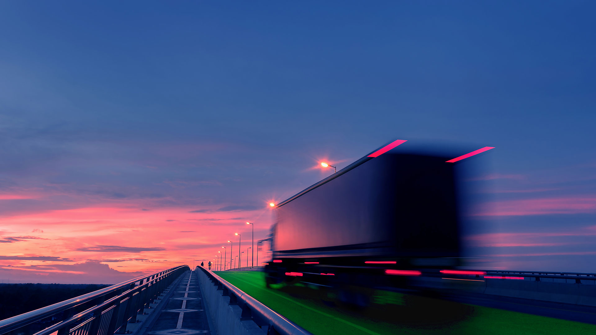 Graphic of a truck in motion driving on a green electric road, at night