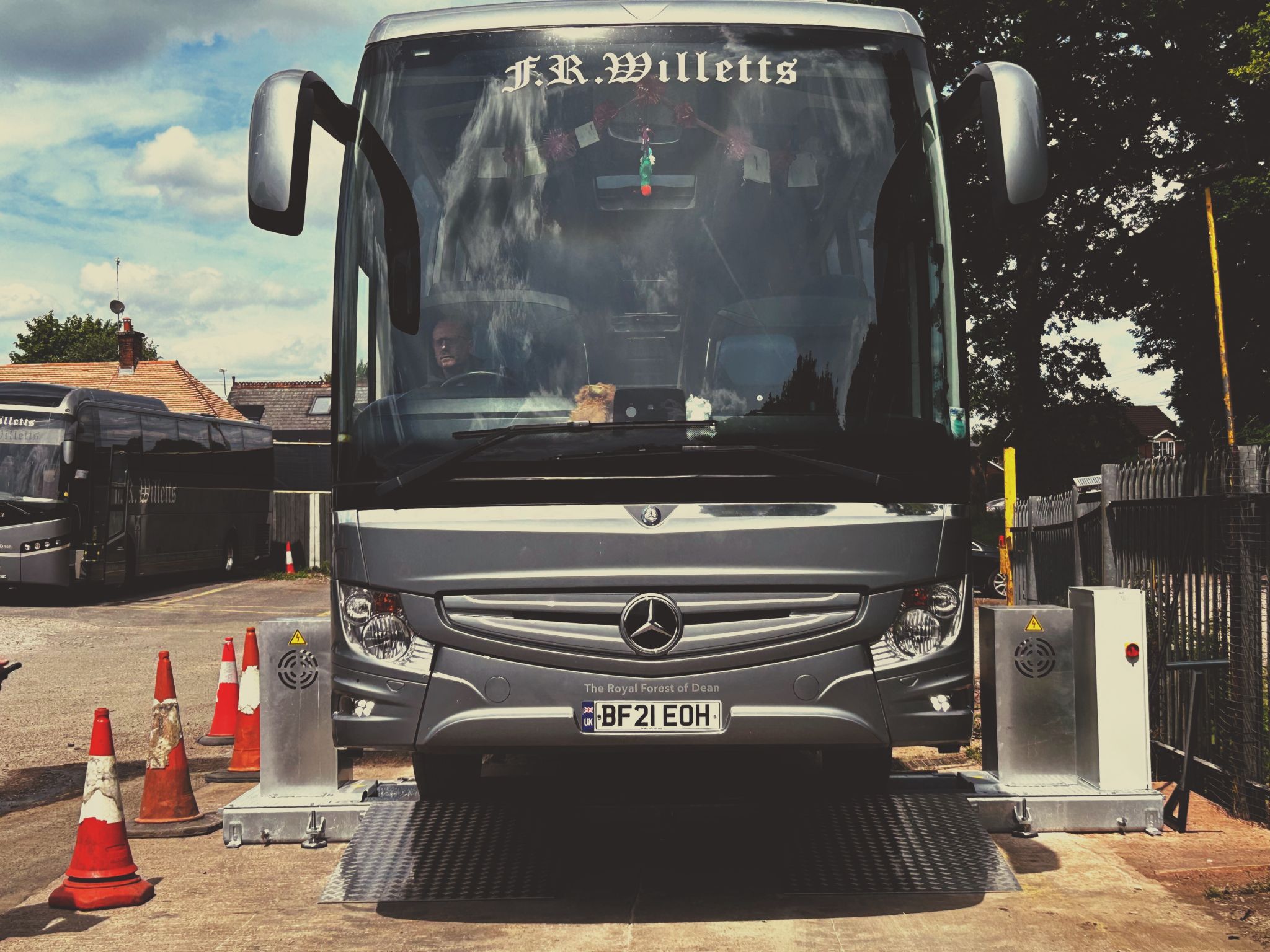 A grey bus photographed from the front