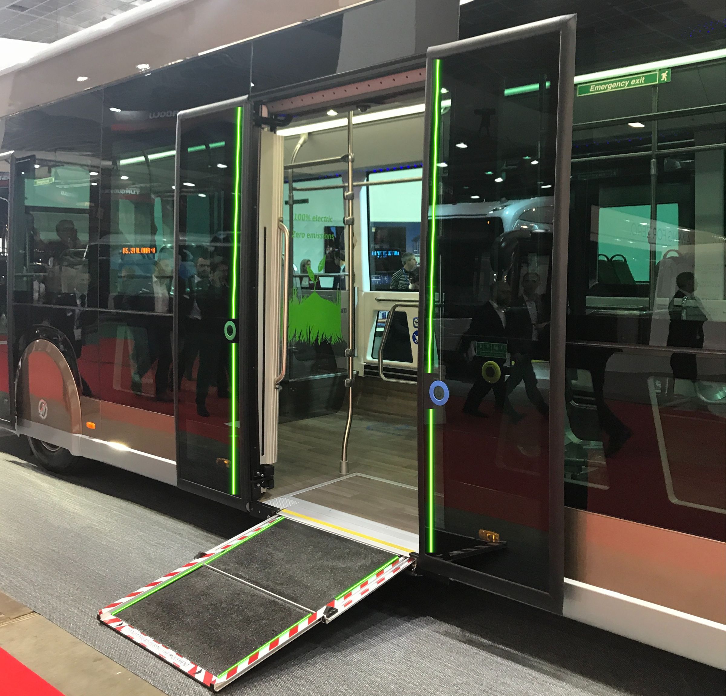 The open door of a bus with an accessibility ramp installed