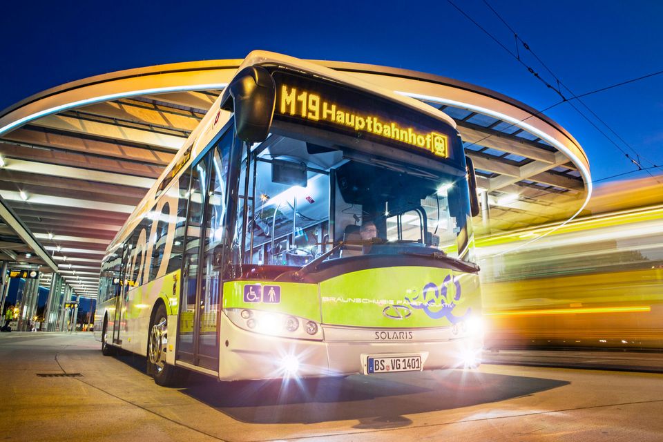 Yellow Solaris bus in motion at night