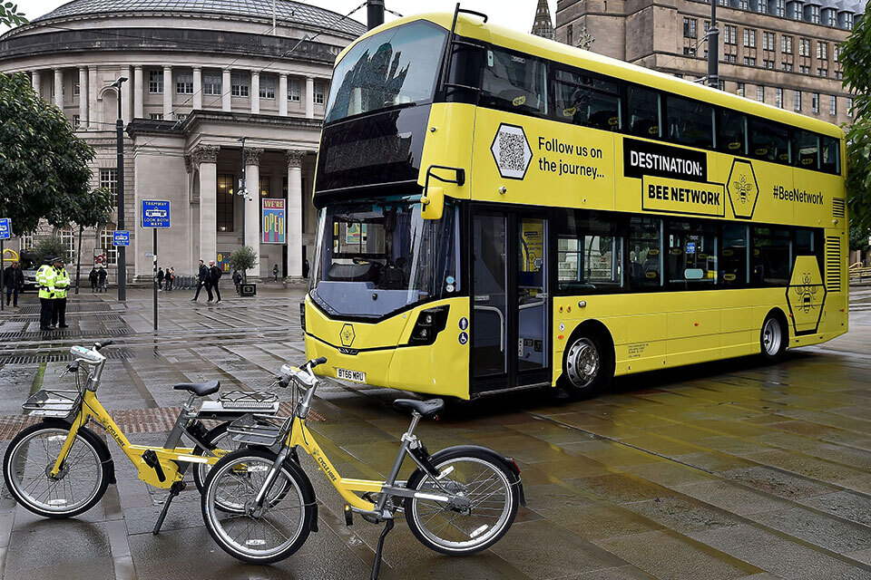 A Bee Network bus and yellow bicycles