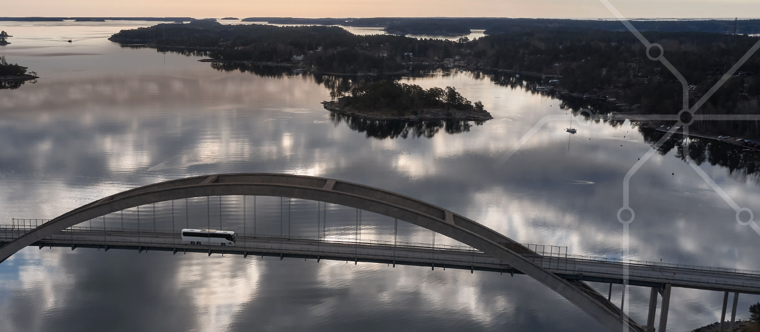 An image of a bus travelling on a bridge across water