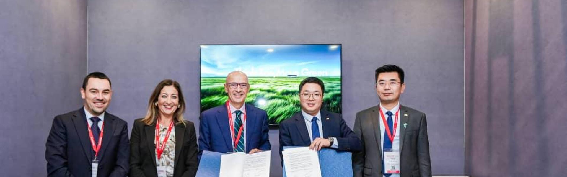 A group of people holding a signed contract agreement