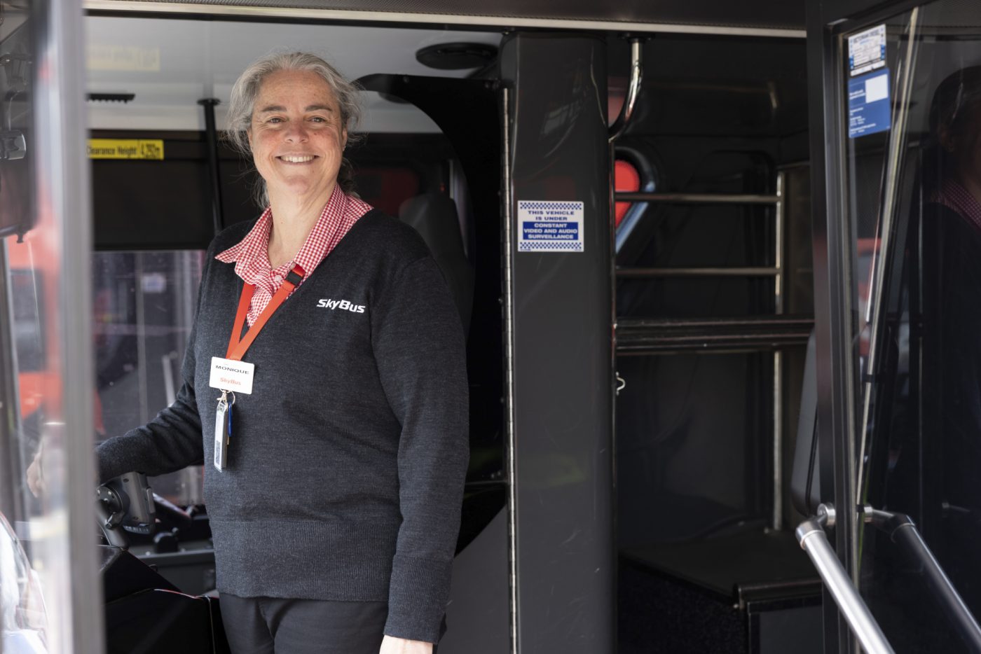 A bus driver smiling to camera
