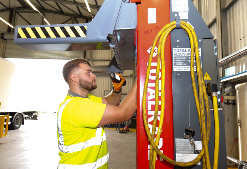 High-vis worker looking at equipment