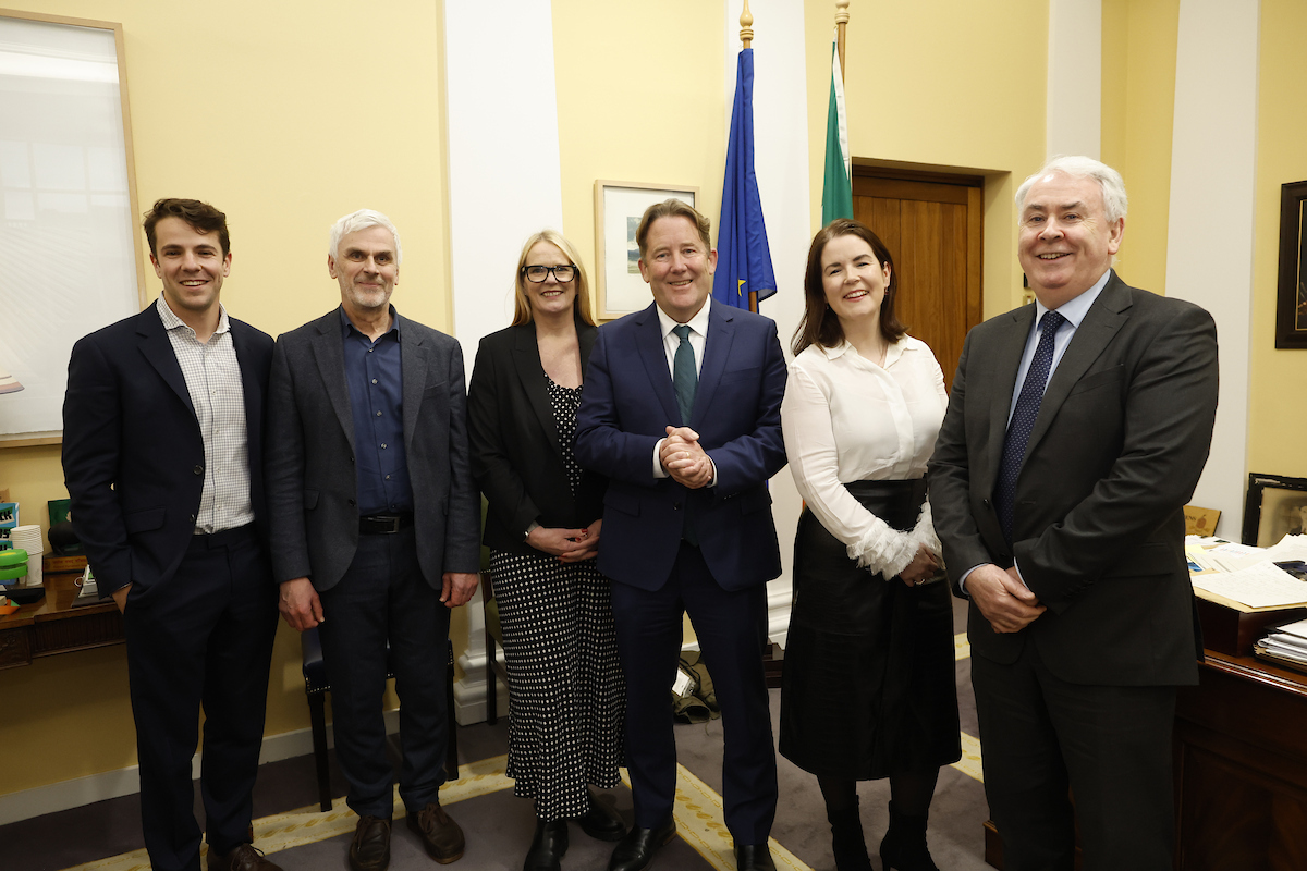 A row of people stood in an office