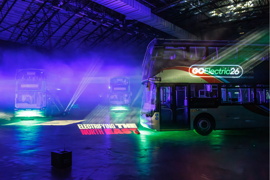 Buses in coloured lighting in a dark venue