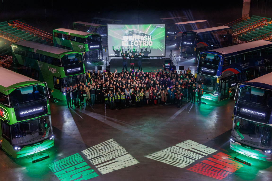 People stood by electric buses during a performance