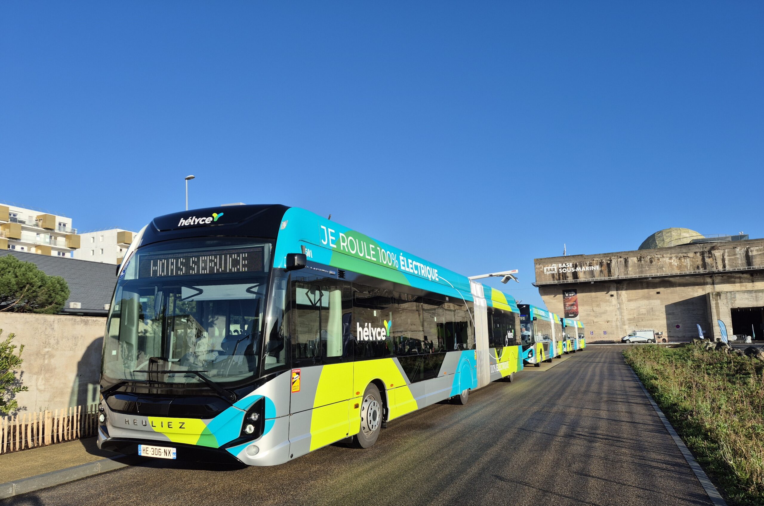 A multicoloured bus by the side of the road