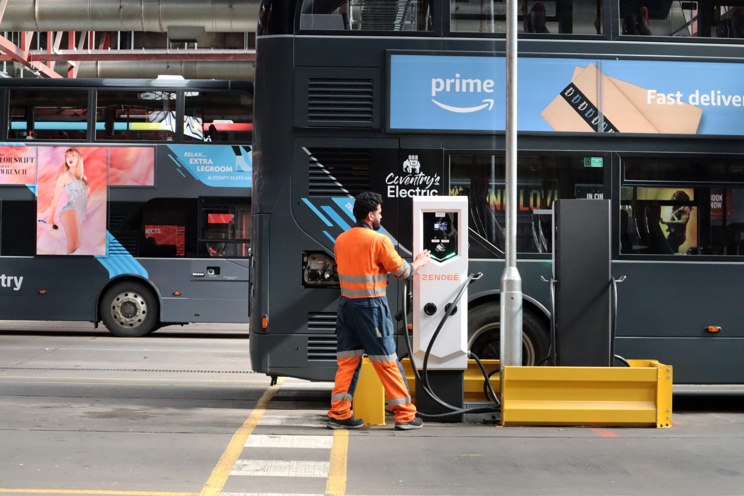 A man refuelling an electric bus