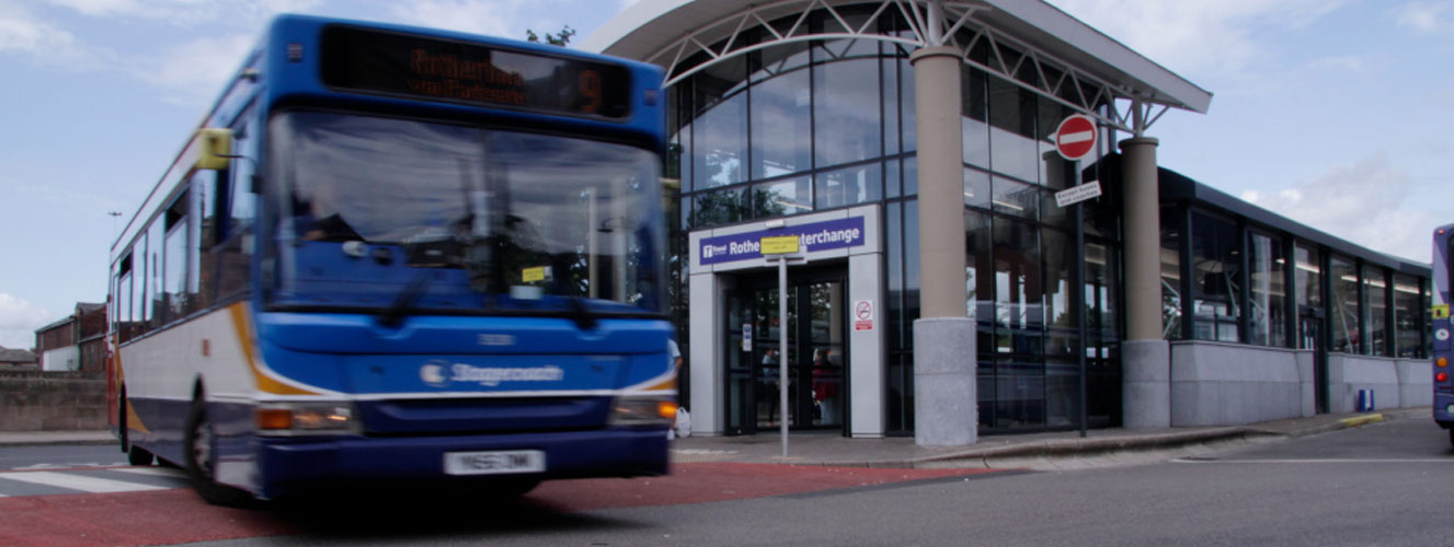 A bus turning by a bus station
