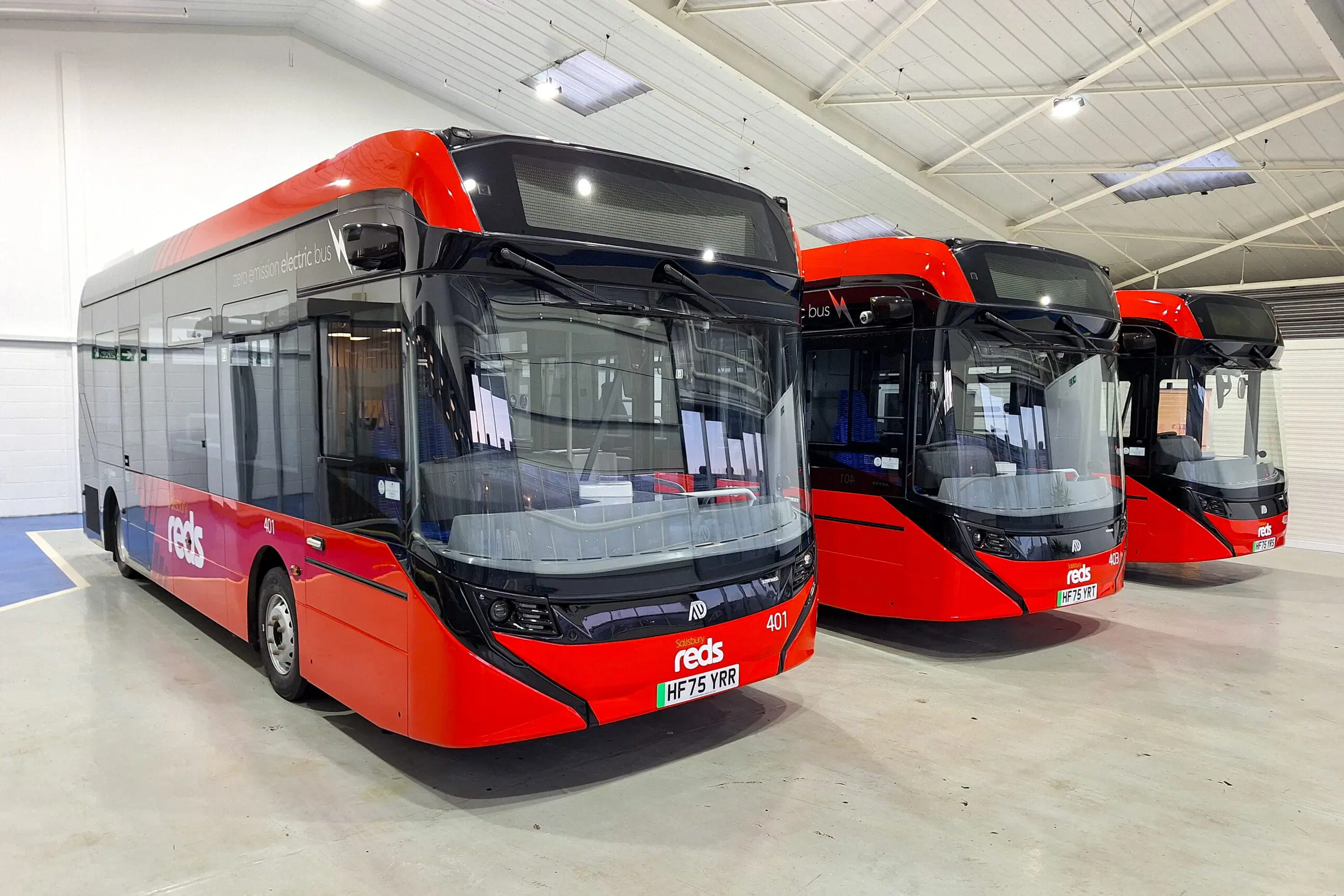 Three bright-red Enviro100 EV buses