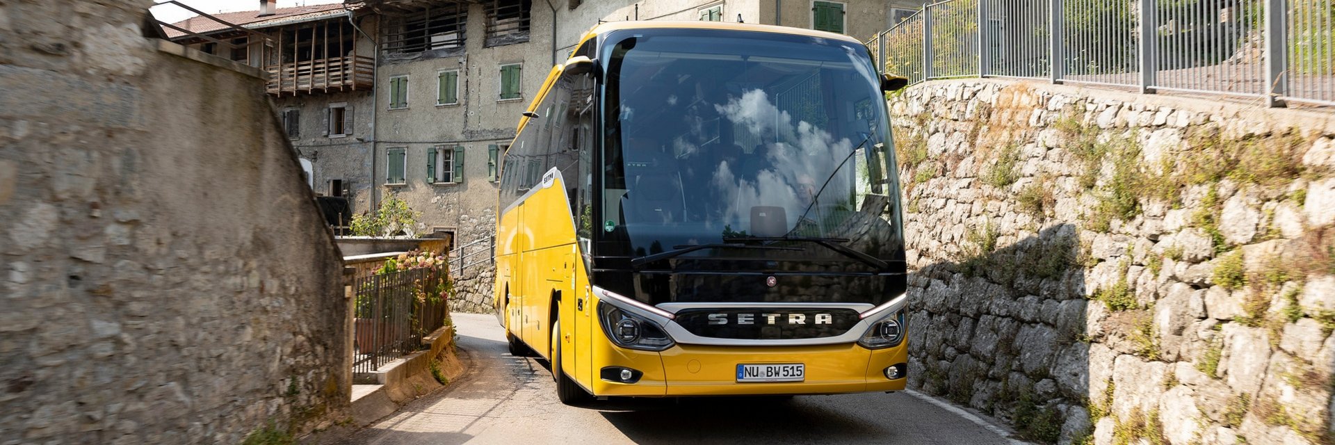 A bus driving up a winding street