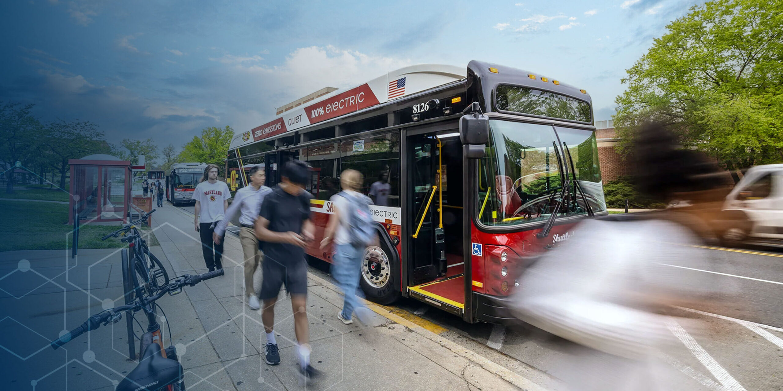 Students passing a red bus