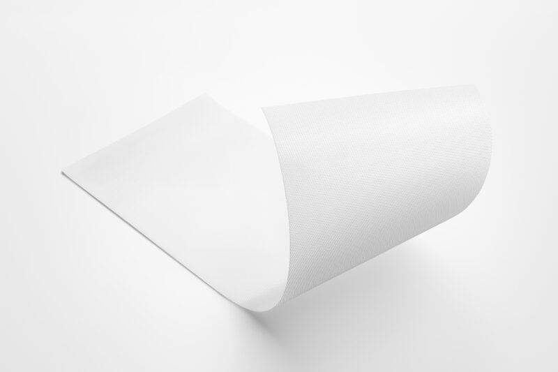 A thin, flexible white film fastener with a fine textured surface, curled upward against a plain white background.