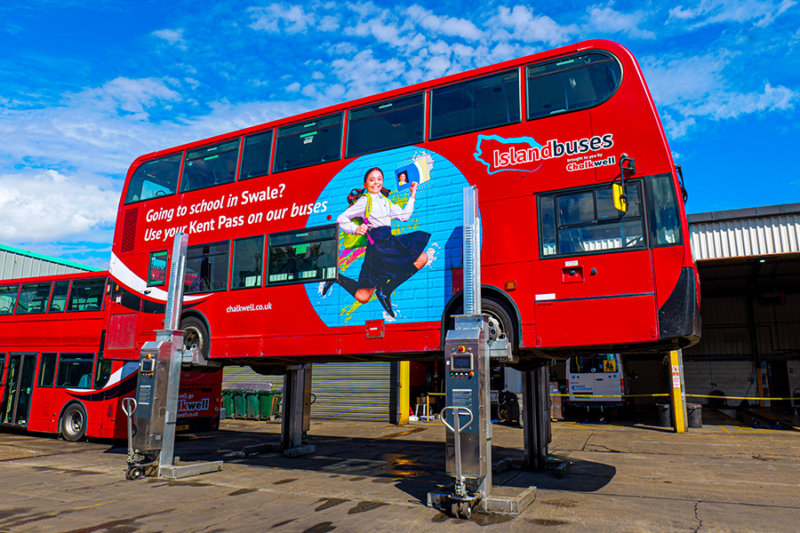 Red Chalkwell Island Buses double-decker raised on four galvanised Totalkare G9DC mobile column lifts outside the depot